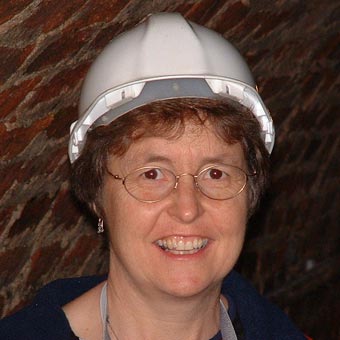 Liz in a hard hat, ready to go down a tunnel