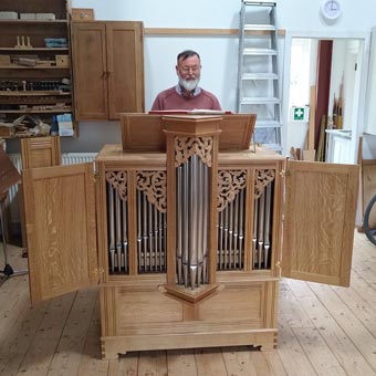 Neil with a small organ he has made